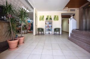 a hallway with potted plants and chairs in a store at El Cortijo Escana in Es Cana +37 photos