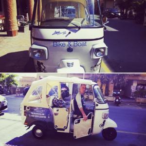 a man is driving a small golf cart at Bike&Boat Argentario Hotel in Porto Santo Stefano