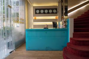 a man sitting at a counter in a restaurant at Cosmopolit in Athens