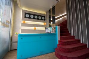 a staircase with red carpeted stairs and a blue counter at Cosmopolit in Athens