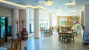 a dining room with tables and chairs in a restaurant at Hotel TEX Club in Botoşani