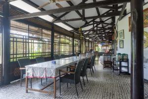 een eetkamer met een lange tafel en stoelen bij Super OYO 942 Srikandi Hotel in Pacitan