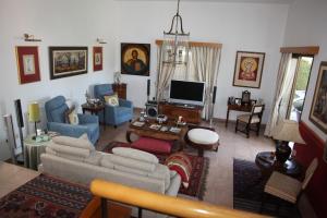 a living room with a couch and a tv at Residence L' Aubrais in Limassol