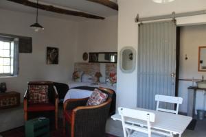 a bedroom with a bed and a table and chairs at Little Artist Cottage in Sutherland