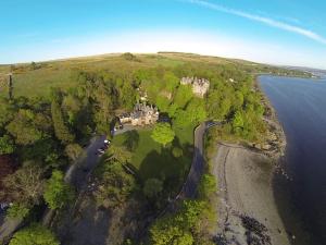 an aerial view of a house on a hill next to the water at Knockderry Country House Hotel in Cove