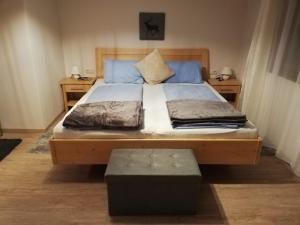 ein Schlafzimmer mit einem großen Bett mit einem Holzrahmen in der Unterkunft Holiday House Spanner in Tauplitz