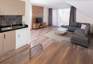 a kitchen and a living room with a couch and a table at Princess Residence in Istanbul