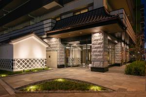 an exterior view of a building at night at Ostay Vermillion Namba in Osaka