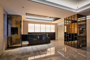 a lobby with glass walls and a counter at Ostay Vermillion Namba in Osaka