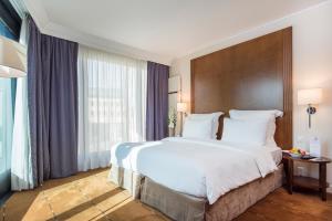 Postel nebo postele na pokoji v ubytování Warwick Geneva