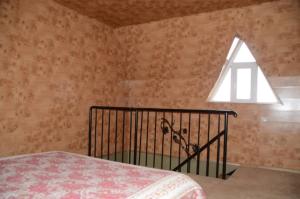 a bedroom with a bed and a window at Guest House Fairy Tale in Kaji-Say