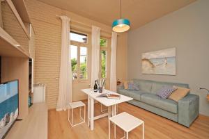 a living room with a couch and a table at VALLE FIORITA 42 - Lake view Studio in Gardone Riviera