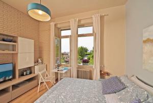 a bedroom with a bed and a desk and a window at VALLE FIORITA 42 - Lake view Studio in Gardone Riviera