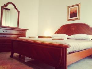 a bedroom with a bed with a mirror and a dresser at A Due Passi in La Maddalena