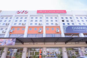 a large building with a sign on top of it at Capital O 854 Ub Caisar Hotel in Banda Aceh