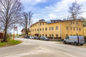 a building with cars parked on the side of a street at Apartmán Theo in Veľký Slavkov