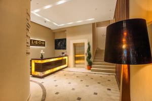 a lobby with a fireplace and a lamp at LETO Boutique Hotel Zugdidi in Zugdidi