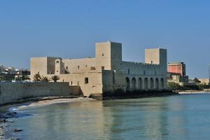 a large building next to a body of water at Casa Gisella in Trani