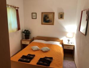 a bedroom with a bed with two towels on it at Apartments Maria in Supetar