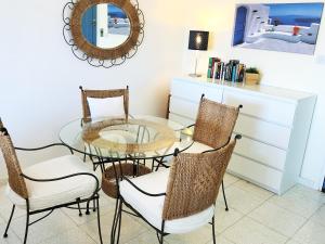 a dining room with a glass table and chairs at Regina Gardens, Phase 1 (Sea View) in Paphos
