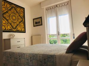 a bedroom with a bed and a large window at La casa di LULU’ in Deiva Marina