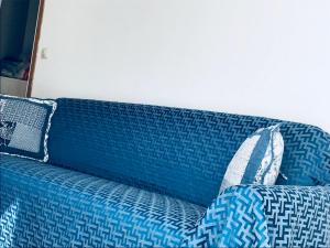 a blue couch with pillows on top of it at La casa di LULU’ in Deiva Marina
