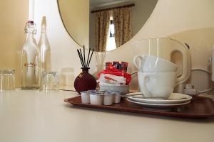 a tray with cups and dishes on a table at Woodview Lodge B&B in Castlebar