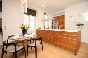 a kitchen with a table and chairs and a counter at Tallinn City Apartments Old Town Square in Tallinn