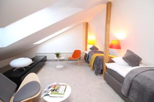 a bedroom with two beds and a loft at Tallinn City Apartments Old Town Square in Tallinn