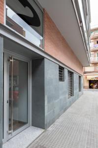 a building with a door on the side of it at Apartamentos Cornellalux in Cornell&agrave; de Llobregat