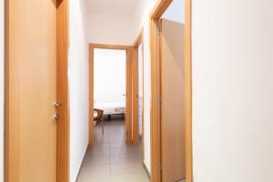 コルネリャー・デ・リョブレガートにあるApartamentos Cornellaluxのベッドルームにつながる2つのドアがある廊下