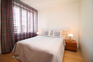 A bed or beds in a room at Tallinn City Apartments - Old Town