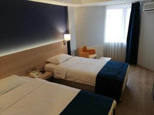 Postel nebo postele na pokoji v ubytování Piskin Hotel