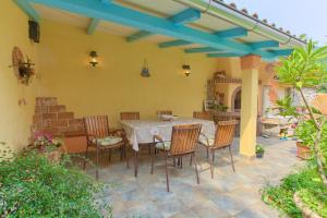 a patio with a table and chairs on a patio at Apartments Rita in Lovran