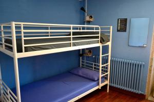 a blue and white bunk bed in a room at Albergue O Fogar de Teodomiro in Santiago de Compostela