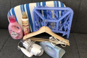 a blue basket with a hair dryer and a bottle of soap at TerraceRin YN14 in Tomigusuku