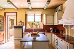 a kitchen with a island with a bowl of fruit on it at Moraitis Mansion in Corfu Town