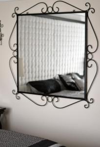 a mirror hanging on a wall in a room at LOTUS by Playa District in Playa del Carmen