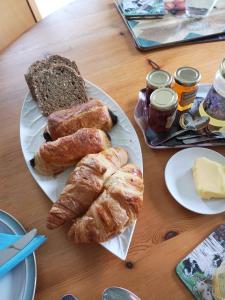 a table with bread and croissants and butter at Room With A View in Mullinavat