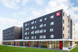a large building with a nk sign on it at ibis budget Gonesse in Gonesse