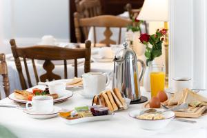 a table with breakfast foods and coffee on it at Shelleven Guest House in Bangor