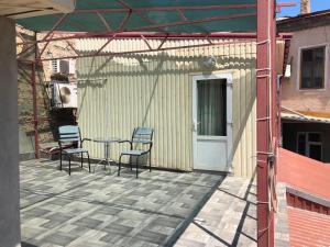 a patio with a table and chairs and a building at Mini-hotel in Odessa Yard in Odesa