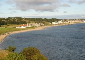 a view of a beach with houses and the water at Breakwater in North Berwick