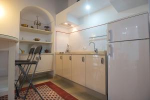a kitchen with a refrigerator and a sink at Casa Convento in Vejer de la Frontera