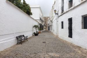 an alley with a bench on a cobblestone street at Casa Convento in Vejer de la Frontera
