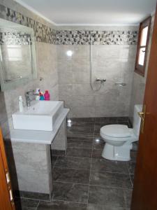a bathroom with a sink and a toilet at Sofirene Sea View in Batsi +37 photos