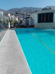 a large blue swimming pool on top of a building at Hotel Windsor in Funchal