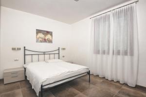 Postel nebo postele na pokoji v ubytování Les Maisons - Ruculì Hospitality
