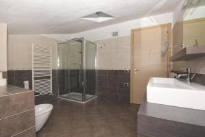 a bathroom with a sink and a shower and a toilet at Villa San Valentino - Ruculì Hospitality in Tignale +38 photos