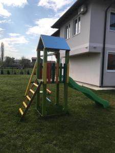 a playground with a slide in a yard at Dream Villa in Sarajevo